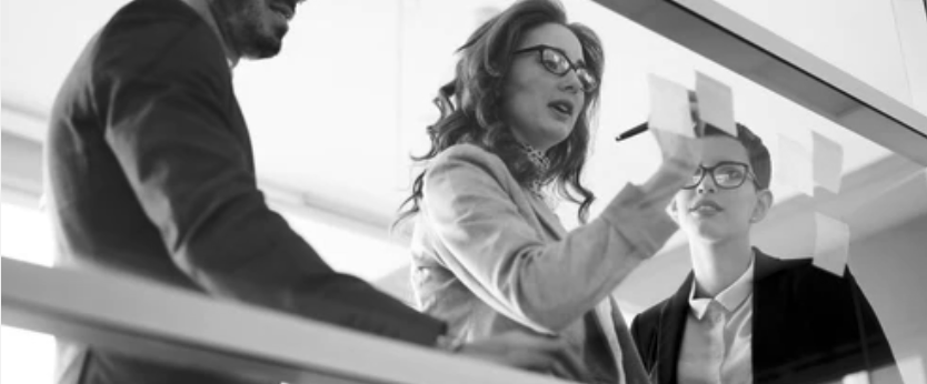 Consulting team collaborating at a whiteboard